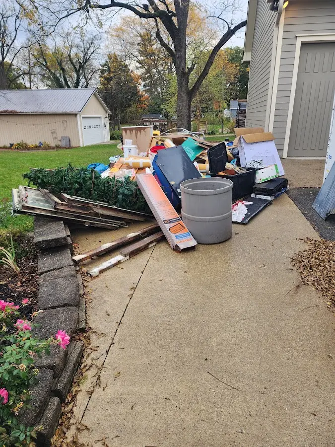 Dumpster being loaded with debris for Estate Cleanout Dumpster Rental in Austell